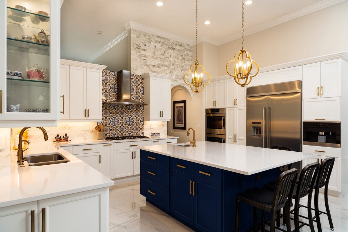 Luxury kitchen remodel by Truelux Fine Homes in Austin, Texas with bold blue island and gold accents